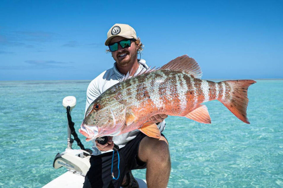 Fisherman with a freshly caught Red Throat Emperor fish