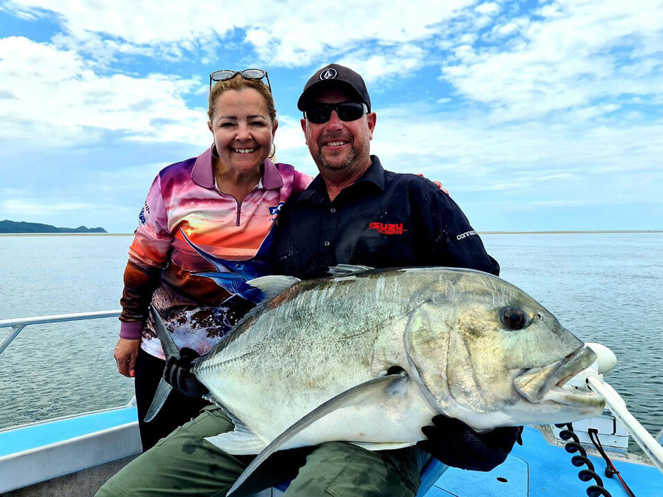 A couple showing their Giant trevally catch