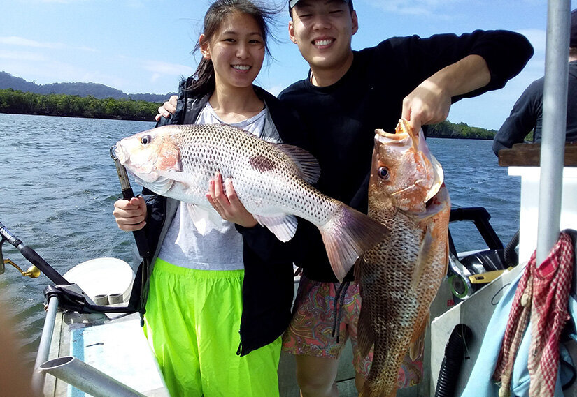 Clients with fish freshly caught on the Daintree River
