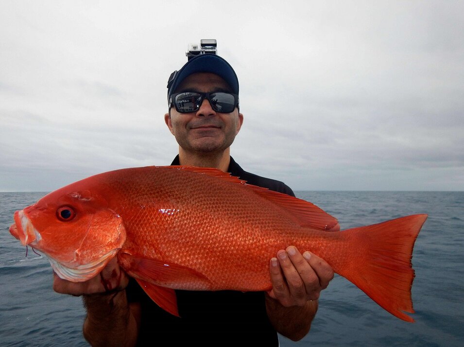male angler with a head mounted camera showing a coral trout