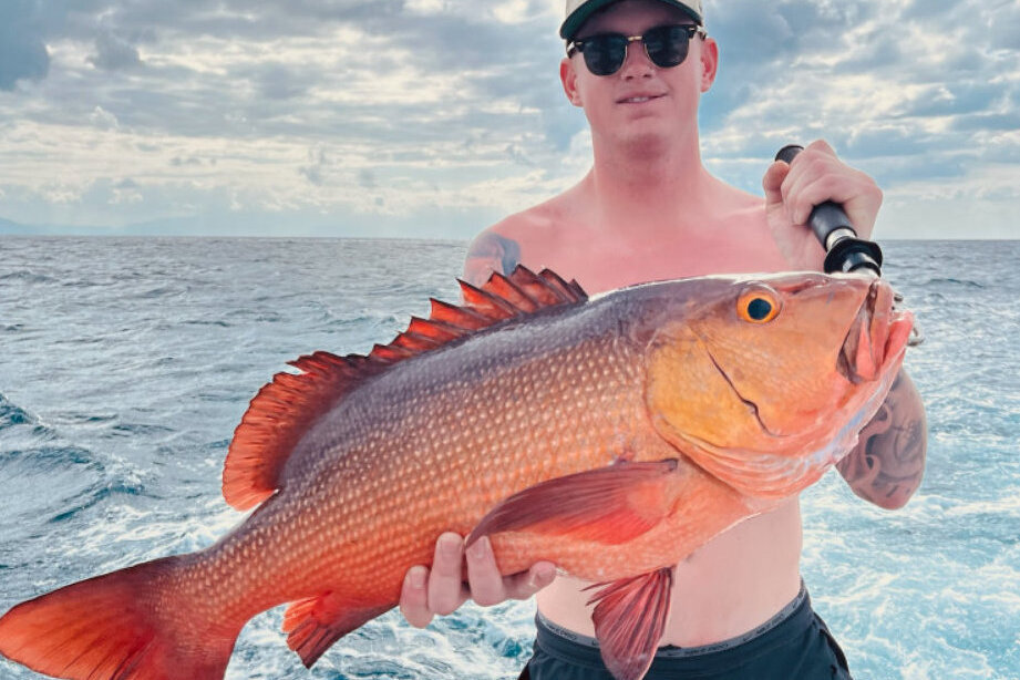 Angler holding a freshly caught Coral trout