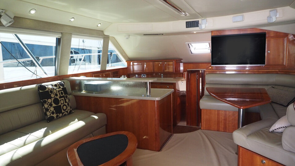 Allure fishing vessel main sitting area with TV