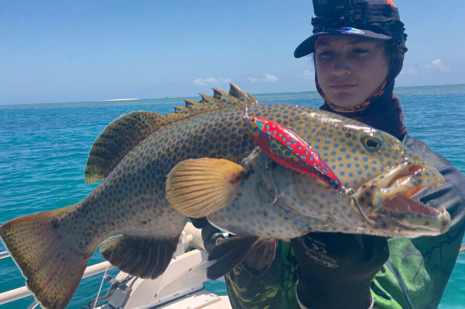 Angler holding a freshly caught Coral trout