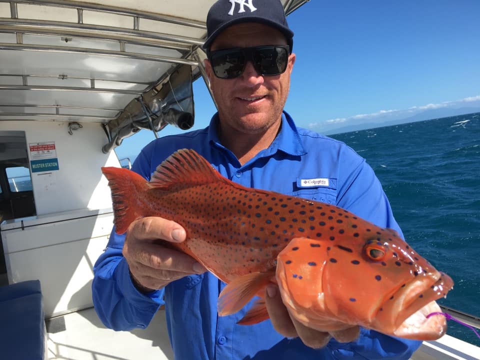 Man showing a Coral trout caught with Dragon Lady fishing charters