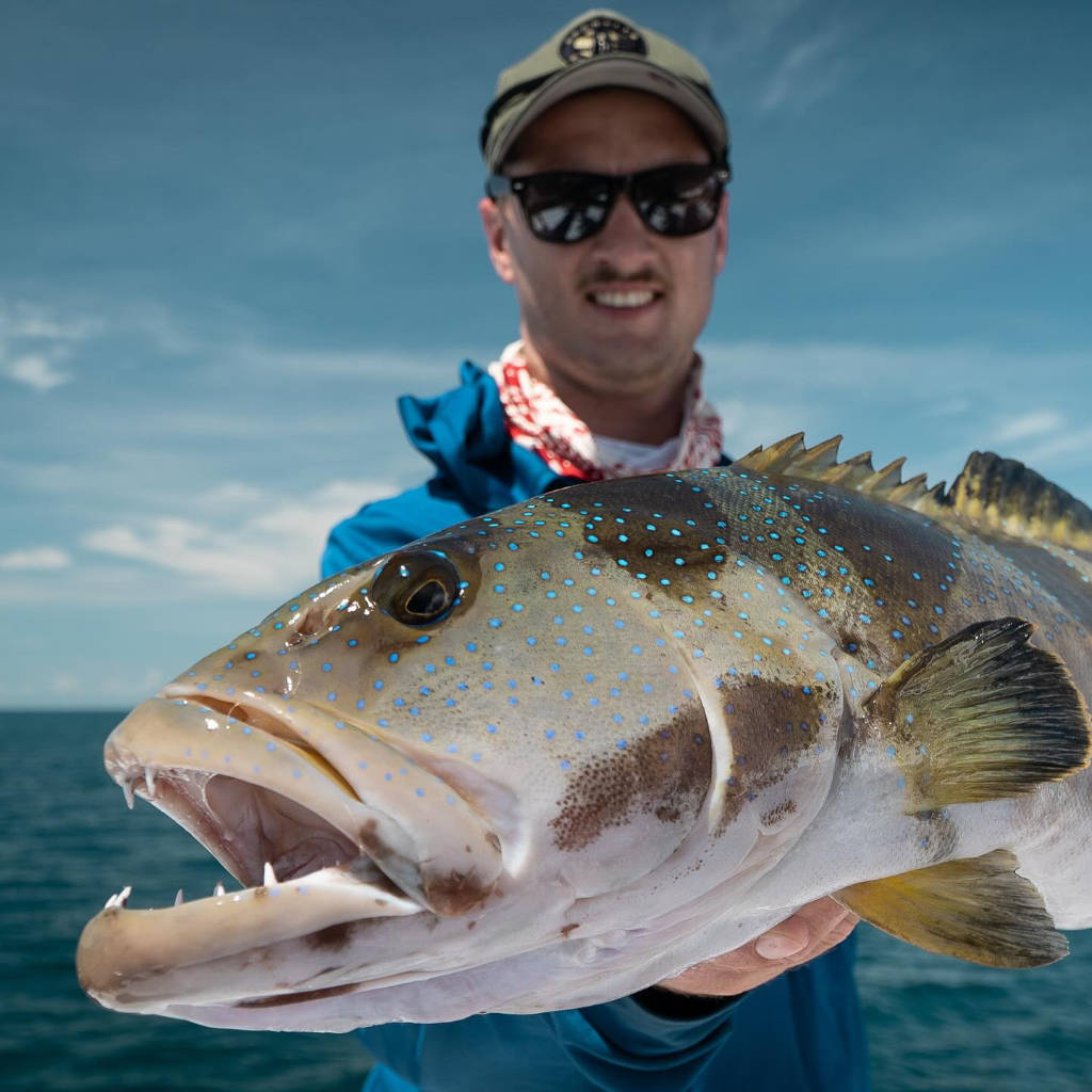 Fisherman with a freshly caught Coral trout