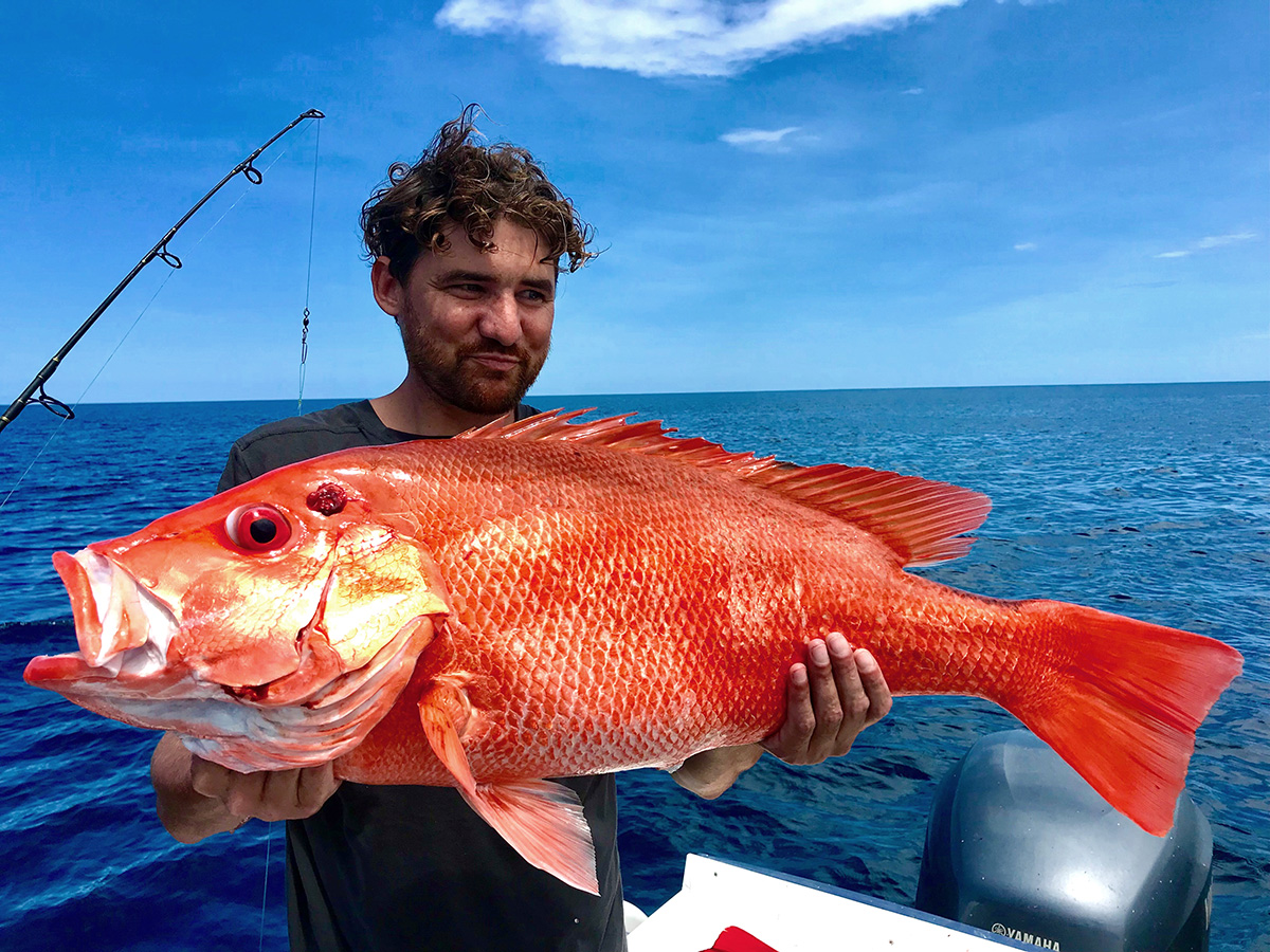 Reef angler holding a large nannygai fish 