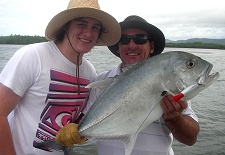 Two river anglers presenting their trevally fish 