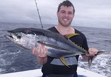 Game Angler holding a large tuna fish