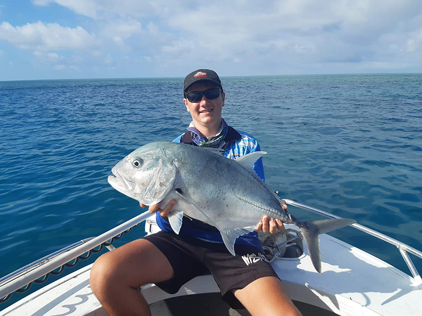 Person with a freshly caught giant trevally